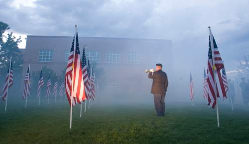 Rick Egan  | The Salt Lake Tribune 

A bugler plays taps during the 911ceremony in front of the Sandy City Hall, Wednesday, September 11, 2013.