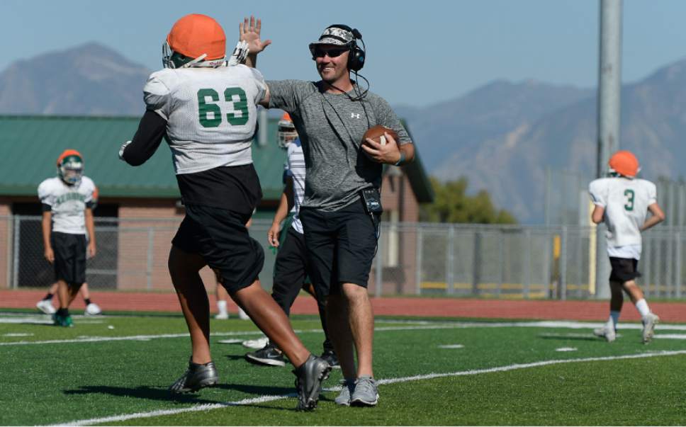 Francisco Kjolseth  |  The Salt Lake Tribune
Kearns football coach Matt Rickards works with his team during practice on Wednesday, Sept. 7, 2016. Coaches across the state, including Rickards, are vehemently criticizing a proposal to eliminate restrictions on prep athletes transferring between schools, saying it would create a free-for-all that encourages athletes focus on winning and entitlement, rather than than character development and overcoming adversity.