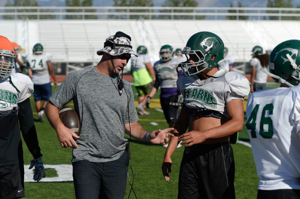 Francisco Kjolseth | The Salt Lake Tribune
Kearns football coach Matt Rickards works with running back Saia Pupua during practice on Wednesday, Sept. 7, 2016. Coaches across the state, including Rickards, are vehemently criticizing a proposal to eliminate restrictions on prep athletes transferring between schools, saying it would create a free-for-all that encourages athletes focus on winning and entitlement, rather than than character development and overcoming adversity.