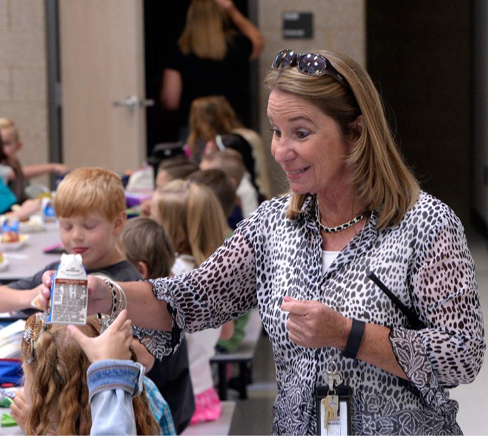 Al Hartmann  |  The Salt Lake Tribune
Principal Christy Waddell good naturedly opens another tricky milk carton for a first year student during first lunch in the cafeteria at the brand new Butler Elementary in Cotonwood Heights Wenesday March 25.  It is one of hundreds of schools that opened Wednesday as students gear up for the 2016-2017 school year.