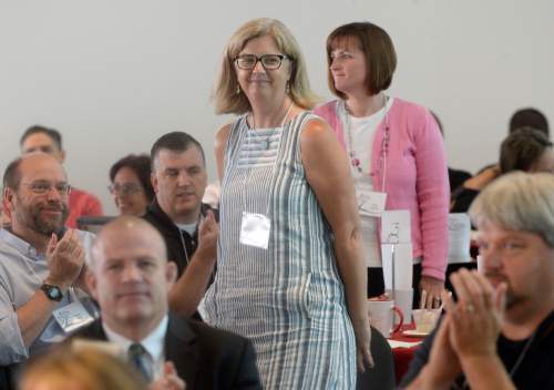 Al Hartmann  |  The Salt Lake Tribune 
Valerie Gates, who teaches English Language Development at West High School stands for applause from fellow teachers for the Salt Lake City School District's 2017 Teacher of the Year Award at Rice-Eccles Stadium Wednesday August 10.  Aline Ashton, (behind) earned Early Childhood Teacher of the Year award. She teaches kindergarten at Whittier Elementary School.