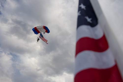 Trent Nelson  |  The Salt Lake Tribune
A skydiver with Mission Volant Sky Divers flies in to present the colors at a September 11th ceremony at the Healing Field in Sandy, Sunday September 11, 2016.