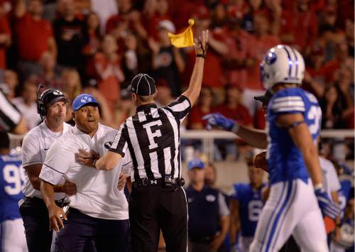 Scott Sommerdorf   |  The Salt Lake Tribune  
BYU head coach Kelani Sitake is flagged as he argues that his DB Francis Bernard should not have been ejected for targeting. Utah defeated BYU 20-19, Saturday, September 10, 2016.