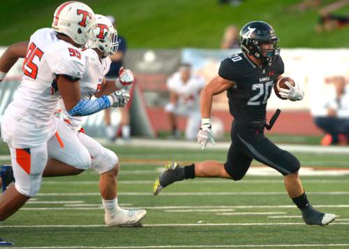 Leah Hogsten  |  The Salt Lake Tribune
Alta's Joshua Davis slips past the defense into the end zone for a touchdown in the first half. Third-ranked Timpview High School leads fifth-ranked Alta High School 24-6 at the half during their Region 7 game, September 9, 2016.