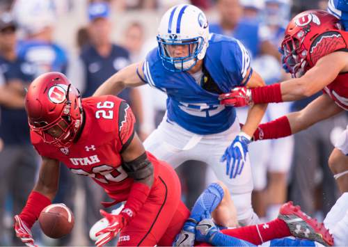 Rick Egan  |  The Salt Lake Tribune

Brigham Young Cougars defensive back Austin McChesney (27) goes for the ball, as Utah defensive back Terrell Burgess (26) loses control of the ball, in second quarter action, BYU vs. Utah at Rice-Eccles Stadium, Saturday, September 10, 2016.