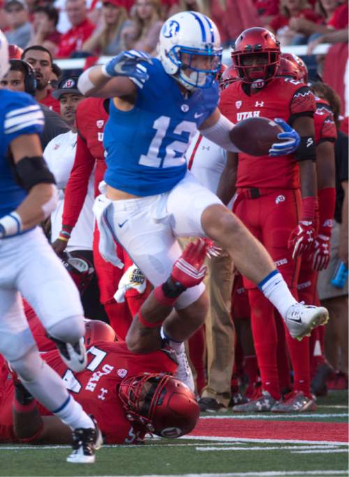 Rick Egan  |  The Salt Lake Tribune

 Brigham Young Cougars defensive back Kai Nacua (12) leaps over his defender as after intercepting a pass, in football action, BYU vs. Utah at Rice-Eccles Stadium, Saturday, September 10, 2016.