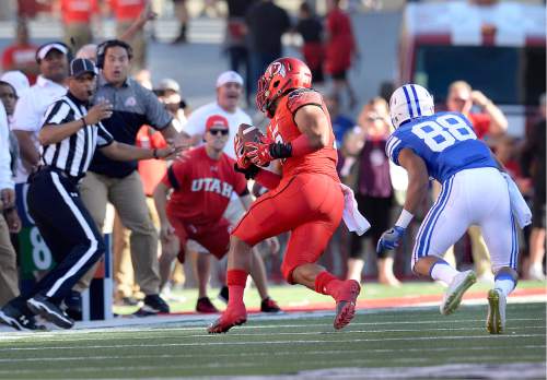 Scott Sommerdorf   |  The Salt Lake Tribune  
Utah LB Sunia Tauteoli turns to run after he grabbed an interception after BYU WR Aleva Hifo bobbled the pass. Tauteoli rumbled 41 yards untouched for the TD on the game's opening play from scrimmage. Utah led BYU 7-6 after one quarter of play, Saturday, September 10, 2016.