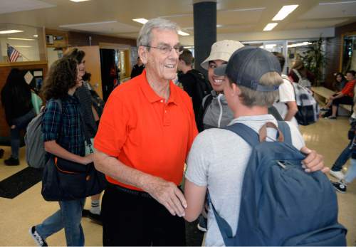 Al Hartmann  |  The Salt Lake Tribune
Dean Collett, 88 years old, a guidance counselor at Highland High School, greets students in the hall during class change Thursday, Sept 1. He started teaching there when the school opened in 1956 and has never left.