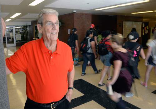 Al Hartmann  |  The Salt Lake Tribune
Dean Collett, 88 years old, a guidance counselor at Highland High School, greets students in the hall during class change Thursday, Sept 1. He started teaching there when the school opened in 1956 and has never left.