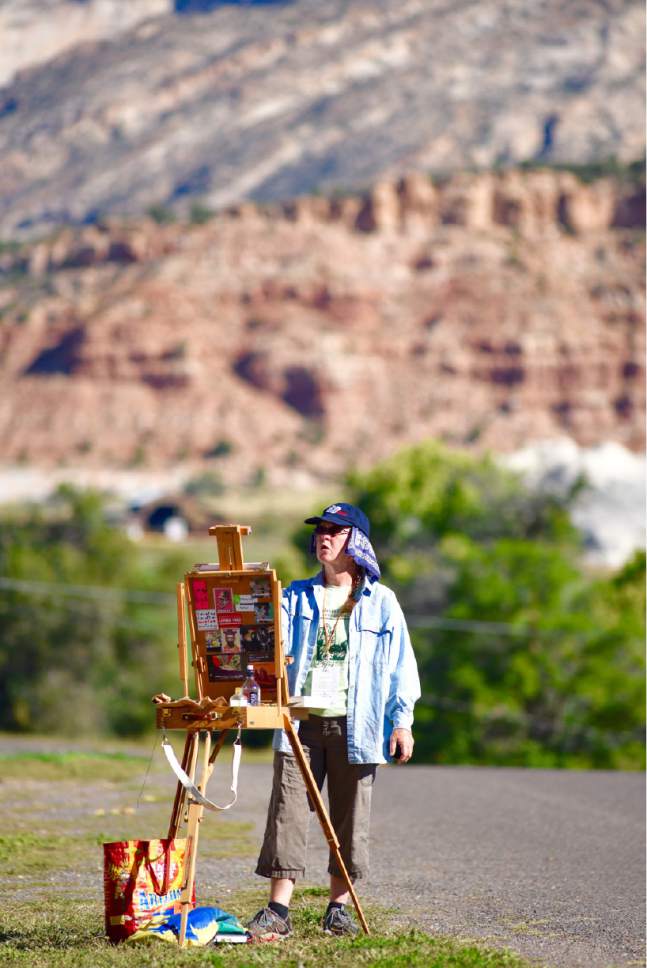 Lynn Johnson  | Special to The Salt Lake Tribune

With the Escalante Valley as a backdrop, Tucson, Ariz., artist Katrina West competes in the Paint the Town - Paint Out as part of the 12th annual Escalante Canyons Art Festival last year.
