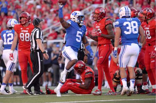 Scott Sommerdorf   |  The Salt Lake Tribune  
BYU DB Dayan Lake leaps up with a fumble recovered from Utah RB Joe Williams during first half play. Utah led BYU 7-6 after one quarter of play, Saturday, September 10, 2016.