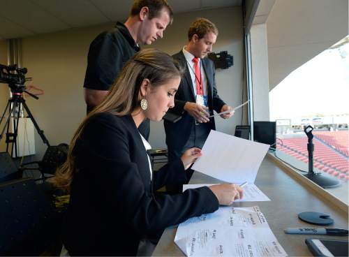 Scott Sommerdorf   |  The Salt Lake Tribune  
Announcers Carla Swensen Haslam and Landon Southwick, right, go over the broadcast plan with producer Nate Moffett, Friday, September 9, 2016. Carla Swensen Haslam, a junior forward on the nationally-ranked BYU women's soccer team, also serves as the color commentator on the broadcast for Real Monarchs matches.