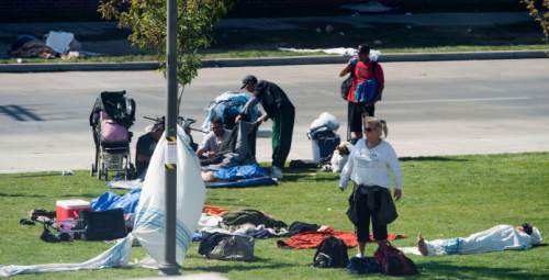 Steve Griffin / The Salt Lake Tribune


People hang out on the grass that runs down 500 west behind the Rio Grande Building in Salt Lake City Thursday September 15, 2016.  The Downtown Alliance has had it with the worsening homeless situation in and around the Rio Grande area.
