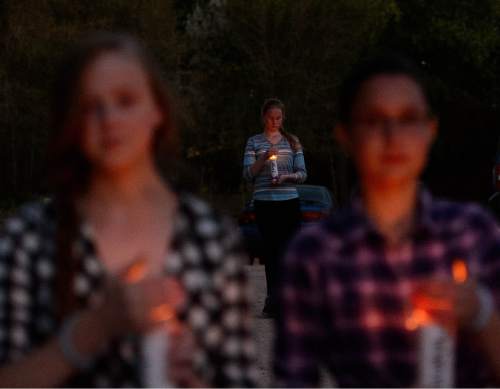 Trent Nelson  |  The Salt Lake Tribune
Leah Draper holds a candle as residents of Hildale, UT and Colorado City, AZ, hold a memorial to the victims of the 2015 flash flood that , Wednesday September 14, 2016. At left is Andrea Jessop, right is Leah Broadbent.