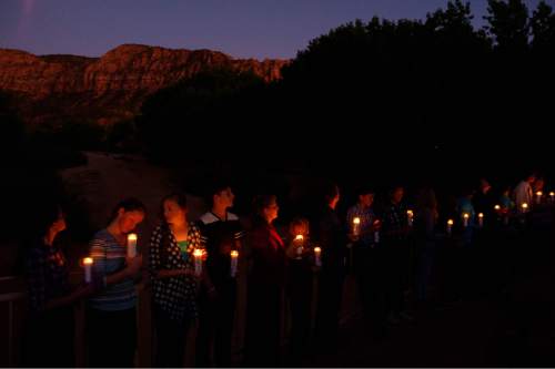 Trent Nelson  |  The Salt Lake Tribune
Residents of Hildale, UT and Colorado City, AZ, hold candles on a bridge over Short Creek during a memorial to the victims of the 2015 flash flood that , Wednesday September 14, 2016.