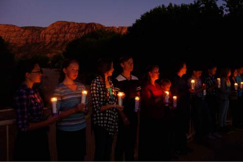 Trent Nelson  |  The Salt Lake Tribune
Residents of Hildale, UT and Colorado City, AZ, hold candles on a bridge over Short Creek during a memorial to the victims of the 2015 flash flood that , Wednesday September 14, 2016.