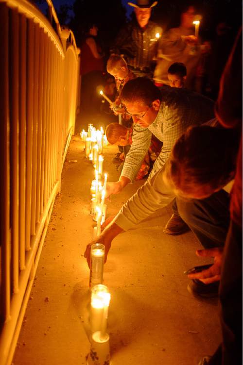 Trent Nelson  |  The Salt Lake Tribune
Residents of Hildale, UT and Colorado City, AZ, light candles at a memorial to the victims of the 2015 flash flood that , Wednesday September 14, 2016.