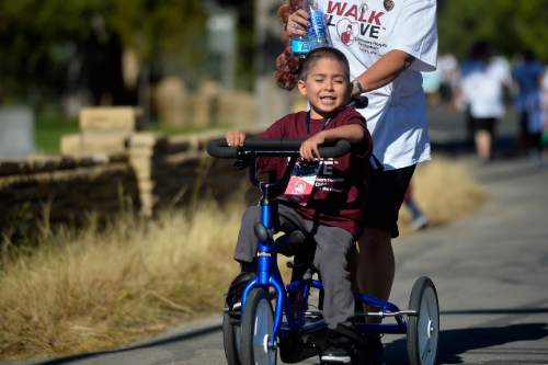 Chris Detrick  |  The Salt Lake Tribune
Adrian Paz, 7, goes along 11th Avenue during Shriners Hospitals for Children "Walk & Roll for Love" Saturday September 17, 2016.