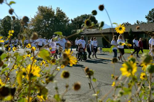 Chris Detrick  |  The Salt Lake Tribune
Participants go along 11th Avenue during Shriners Hospitals for Children "Walk & Roll for Love" Saturday September 17, 2016.