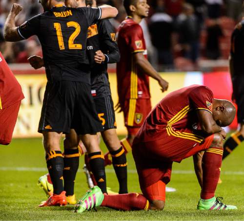Trent Nelson  |  The Salt Lake Tribune
Real Salt Lake defender Jamison Olave (4) takes a knee while Houston players celebrate the win as time runs out as Real Salt Lake hosts the Houston Dynamo, Saturday September 17, 2016.