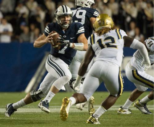 Rick Egan  |  The Salt Lake Tribune

Brigham Young quarterback Taysom Hill (7) tries to out run UCLA Bruins linebacker Jayon Brown (12) as runs are ball for the Cougars, in football action, BYU vs, UCLA, at Lavell Edwards Stadium, Saturday, September 17, 2016.