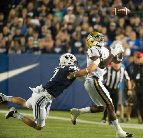 Rick Egan  |  The Salt Lake Tribune

Brigham Young Cougars defensive back Micah Hannemann (7) breaks up a pass intended for UCLA Bruins wide receiver Ishmael Adams (1) in football action, BYU vs, UCLA, at Lavell Edwards Stadium, Saturday, September 17, 2016.