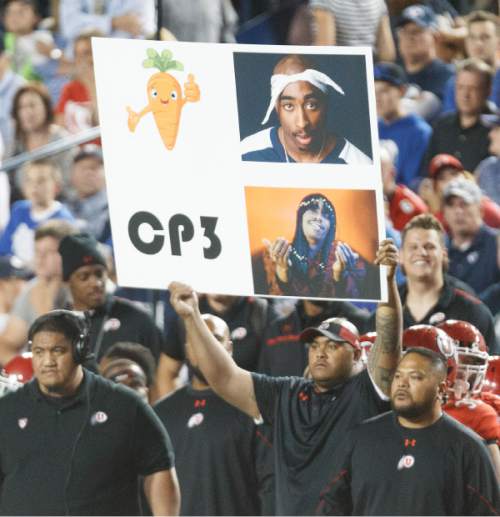 Trent Nelson  |  The Salt Lake Tribune
Utah calls a play with a sign feature a carrot and Tupac in the second quarter as the BYU Cougars host the Utah Utes, college football Saturday, September 21, 2013 at LaVell Edwards Stadium in Provo.