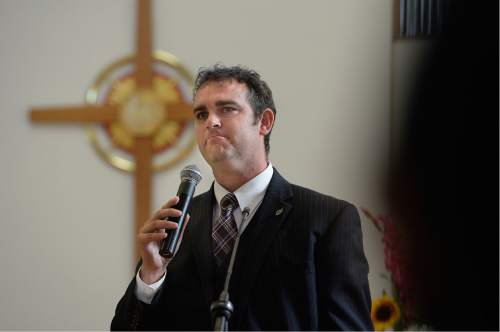 Scott Sommerdorf   |  The Salt Lake Tribune  
Cameron Lewis pauses to compose himself as he speaks about his friend, Philip Aguto, during the memorial service for him, Sunday, August 28, 2016 at All Saints Episcopal Church. Lewis met Aguto when they both worked at the LDS print center when Aguto was a book binder in 2001, and Lewis was his home teacher. Aguto was killed in a hit-and-run accident. in mid-August. He was part of the 20,000 Lost Boys of Sudan, and came to the U.S. in 2001, later becoming a citizen.