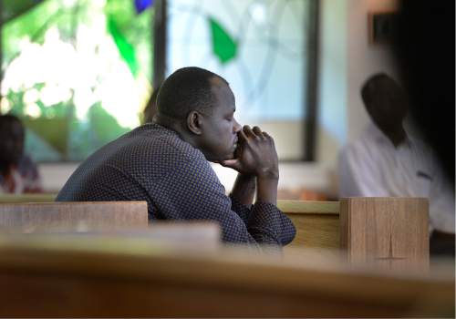Scott Sommerdorf   |  The Salt Lake Tribune  
Alual Bul listens in the pews at All Saints Episcopal Church, during the memorial service for 36-year-old Philip Aguto, Sunday, August 28, 2016. Aguto, a friend to many of these fellow South Sudanese, was killed in a hit-and-run accident. in mid-August. He was part of the 20,000 Lost Boys of Sudan, and came to the U.S. in 2001, later becoming a citizen.
