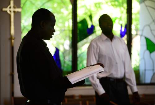 Scott Sommerdorf   |  The Salt Lake Tribune  
South Sudanese men sing during the Sunday worship service underway at All Saints Episcopal Church, just prior to the memorial service for 36-year-old Philip Aguto, Sunday, August 28, 2016. Aguto was killed in a hit-and-run accident. in mid-August. He was part of the 20,000 Lost Boys of Sudan, and came to the U.S. in 2001, later becoming a citizen.