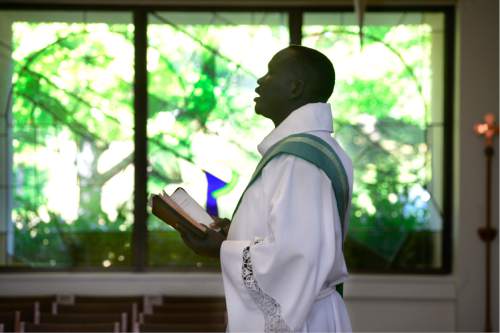Scott Sommerdorf   |  The Salt Lake Tribune  
The Rev. Gabriel Atem, conducts Sunday worship service at All Saints Episcopal Church, just prior to the memorial service for 36-year-old Philip Aguto, Sunday, August 28, 2016. Aguto was killed in a hit-and-run accident. in mid-August. He was part of the 20,000 Lost Boys of Sudan, and came to the U.S. in 2001, later becoming a citizen.