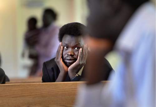 Scott Sommerdorf   |  The Salt Lake Tribune  
Deng Dau listens in the pews at All Saints Episcopal Church, during the memorial service for 36-year-old Philip Aguto, Sunday, August 28, 2016. Aguto, a friend to many of these fellow South Sudanese, was killed in a hit-and-run accident. in mid-August. He was part of the 20,000 Lost Boys of Sudan, and came to the U.S. in 2001, later becoming a citizen.