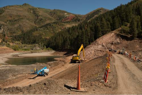 Leah Hogsten  |  The Salt Lake Tribune
Construction at Tibble Fork reservoir, September 13, 2016 in an effort to make the dam, larger, seismically safe and extend its life for another 50 years. The lake bed sediment, loaded with arsenic, lead and other toxic metals from historical mining operations at the scenic canyon's headwaters, was too costly for removal, so the option was abandoned in favor of raising the dam by 9 feet. Although irrigation is the main and historic use of the reservoir, Utahns use the canyon for recreation and play in the streambed.  The headwaters of American Fork is perforated with abandoned mines that environmentalists and county leaders say is threatening the precious watershed.