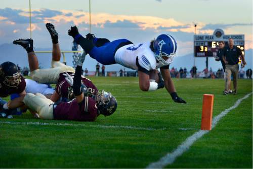 Scott Sommerdorf   |  The Salt Lake Tribune  
Bingham RB Jahvontay Smith leaps for a TD to give Bingham a 21-3 lead during first half play. Bingham led Lone Peak 21-9 at the half, Friday, September 2, 2016.