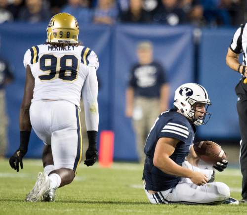 Rick Egan  |  The Salt Lake Tribune

Brigham Young quarterback Taysom Hill (7) is slow to get up, after being sacked by UCLA Bruins defensive lineman Takkarist McKinley (98), in football action, BYU vs, UCLA, at Lavell Edwards Stadium, Saturday, September 17, 2016.