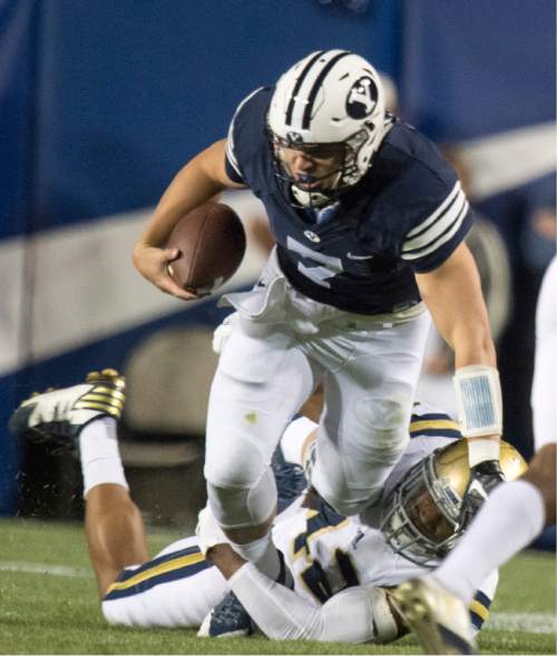 Rick Egan  |  The Salt Lake Tribune

Brigham Young Cougars quarterback Taysom Hill (7) is brought down by UCLA Bruins linebacker Jayon Brown (12), in football action, BYU vs, UCLA, at Lavell Edwards Stadium, Saturday, September 17, 2016.