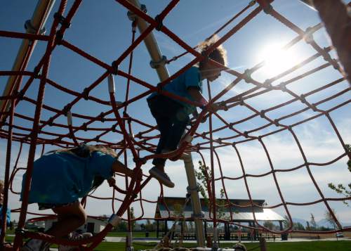 Al Hartmann  |  The Salt Lake Tribune
Children from Kearns Recreation Center day care program are the first to play on the amazing playground at the new Lodestone Parkat at 6200 South 6200 West on Tuesday. Salt Lake County Mayor Ben McAdams and government officials from Kearns and West Valley City dedicated the new regional park built with funds from a 2012 parks bond on the Kearns/West Valley City border. Larry H. Miller Charities donated several outdoor basketball courts to the park.