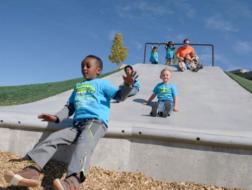 Al Hartmann  |  The Salt Lake Tribune
Children from Kearns Recreation Center day care program are the first to break in the amazing playground at the new Lodestone Park at 6200 S. 6200 W. Tuesday September 20.   Salt Lake County Mayor Ben McAdams and government officials from Kearns and West Valley City dedicated the new regional park built with funds from a 2012 parks bond on the Kearns/West Valley City border.  Larry H. Miller Charities donated several outdoor basketball courts to the park.