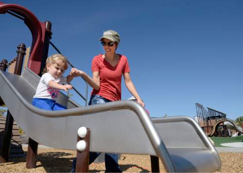 Al Hartmann  |  The Salt Lake Tribune
Jessica Stewart with 18-month-old son Jaimie try out one of many slides on the amazing playground at the new Lodestone Park at 6200 S. 6200 W. Tuesday September 20.   Salt Lake County Mayor Ben McAdams and government officials from Kearns and West Valley City dedicated the new regional park built with funds from a 2012 parks bond on the Kearns/West Valley City border.  Larry H. Miller Charities donated several outdoor basketball courts to the park.
