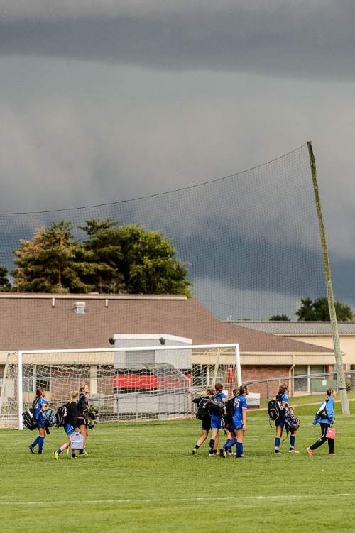 Trent Nelson  |  The Salt Lake Tribune
Fremont players walk off the field as a lightning storm moves in, as Weber hosts Fremont high school soccer in Ogden, Thursday September 22, 2016.