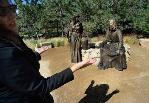 Scott Sommerdorf   |  The Salt Lake Tribune  
describes her sculpture "I Give You Living Water" - John 4:4-42, Thursday, September 22, 2016, in the The Light of the World garden.