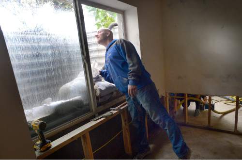 Scott Sommerdorf   |  The Salt Lake Tribune  
Dave Nelson looks out the window that broke from the pressure of mud and water forcing it's way into his home's basement, Friday, September 23, 2016. The overnight storm that brought flooding to homes on Cedar Drive in Price caused damage to many homes in the area.