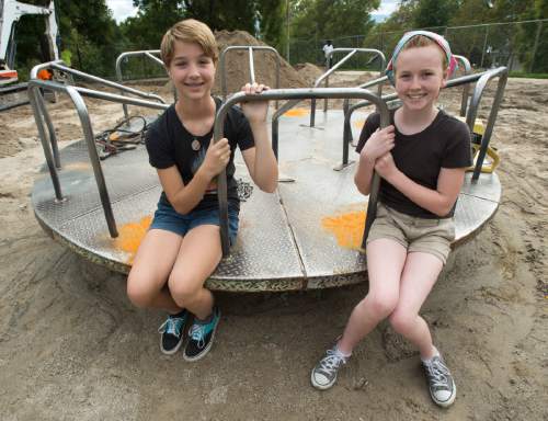 Rick Egan  |  The Salt Lake Tribune
Teddy Stevens, left, 12, and Mabel Bates, 12, helped save the merry-go-round at Lindsey Gardens.