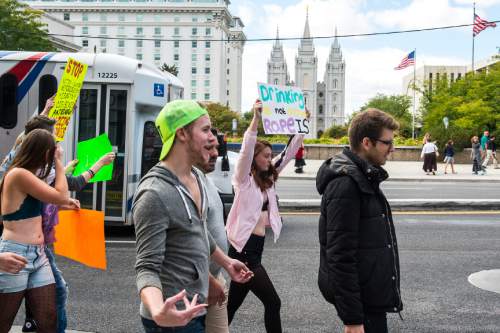 Chris Detrick  |  The Salt Lake Tribune
Participants walk past Temple Square on their way to the state Capitol during the 5th annual SlutWalk Walk of No Shame Saturday September 24, 2016. The annual SlutWalk is a march against sexual assault, victim blaming, slut shaming, and rape culture- with millions of participants in thousands of cities around the globe. The Walk of No Shame aims to strike down the ideas that survivors of sexual assault or violence somehow deserved it, or that anyone is inviting this behavior. By dismantling this idea, and the culture that surrounds it, we hope to see better access to help for survivors, better reporting methods, and less stigma around reporting these crimes.