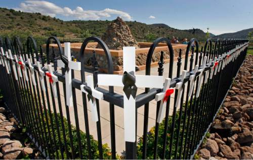 Wooden crosses adorn the black wrought iron fence that surrounds the Mountain Meadows Massacre Grave Site Memorial near Enterprise, UT Sept. 7, 2007.  Steve Griffin/The Salt Lake Tribune 9/10/07