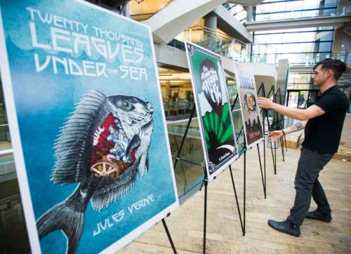 Steve Griffin / The Salt Lake Tribune


Andrew Shaw and Tommy Hamby install the "Reconsidering the Classics" exhibit at the Salt Lake City Main Library in Salt Lake City on Thursday, Sept. 22, 2016.  The exhibit features new artwork for classic books, including Shakespeare plays. It's part of the Utah Book Festival and Library's partnership that is also hosting a copy of Shakespeare's First Folio.