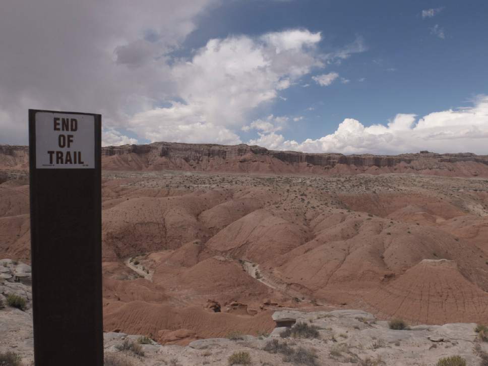 Nate Carlisle  |  The Salt Lake Tribune

A sign marks the end of the Curtis Bench Trail in Goblin Valley State Park on Sept. 11, 2016. The Henry Mountains can be seen in the distance