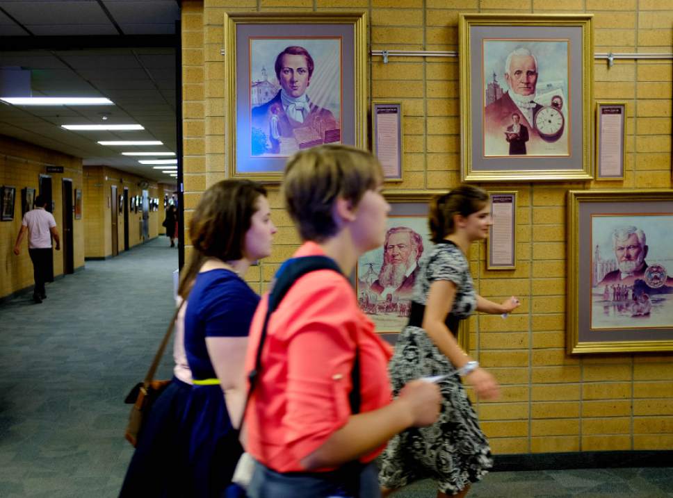 Trent Nelson  |  The Salt Lake Tribune
Missionaries walk past portraits of past church leaders at the Missionary Training Center of the Church of Jesus Christ of Latter-day Saints in Provo Tuesday June 18, 2013.