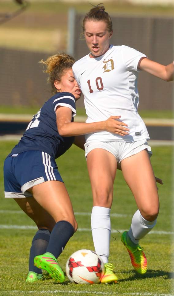 Leah Hogsten  |  The Salt Lake Tribune
Davis' Olivia Wade battles Hunter's Alexus Lovato. Davis High School girls' soccer program, currently ranked No. 1 nationally by USA Today, established the new UHSAA record for most consecutive wins with their 37th straight win against Hunter High School 13-0, September 27, 2016.