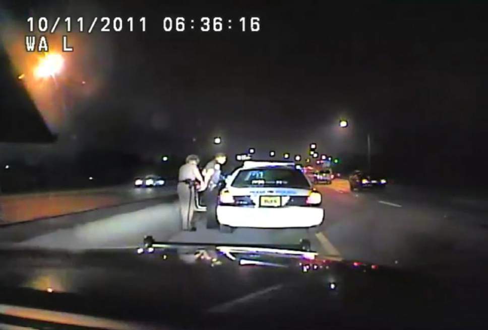In this image made from an Oct. 11, 2011 video made available by the Florida Department of Highway Safety and Motor Vehicles, Florida Highway Patrol Officer Donna Watts arrests Miami Police Department Officer Fausto Lopez who was traveling at 120 miles per hour to an off-duty job, in Hollywood, Fla. After the incident, Watts says that she was harassed with prank calls, threatening posts on law enforcement message boards and unfamiliar cars that idled near her home. In lawsuits, she accused dozens of officers of obtaining information about her in the state's driver database. (Florida Department of Highway Safety and Motor Vehicles via AP)